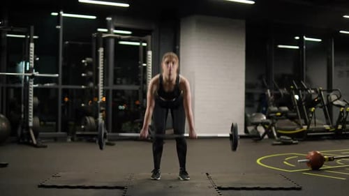 Strong Woman Lifting Weights in the Gym
