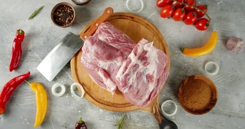 Raw Pork on Cutting Board with Ingredients