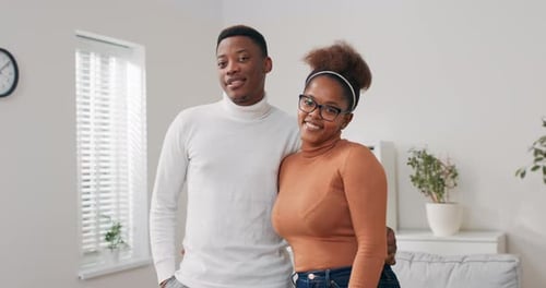 A Couple in Love Moves Into a New Apartment Cardboard Boxes with Packed Things Stand in the Living
