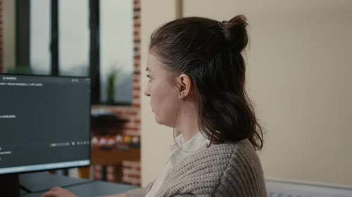 Portrait of Focused Software Engineer Writing Code Looking at Multiple Computer Screens