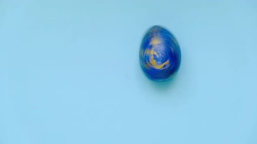 Easter Egg are Spinning Turning on Blue Table