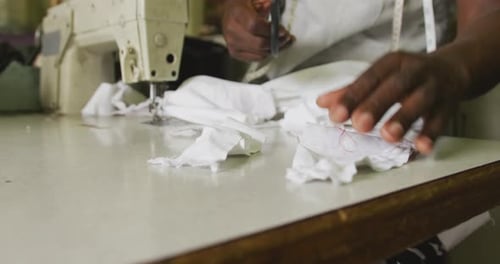 Tailor Cutting Fabric at Sewing Machine