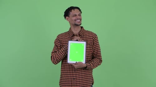 Young Man Holding Tablet with Green Screen