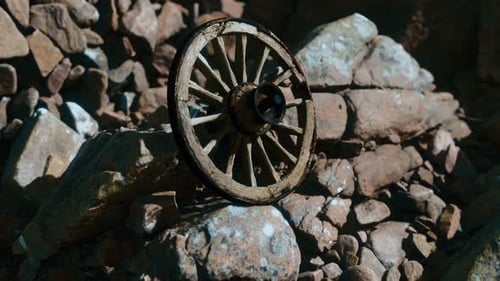 Rustic Wooden Wagon Wheel in Rocky Landscape