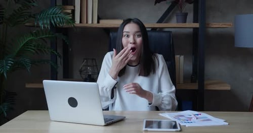 Woman Reacts with Shock then Excitement at Computer