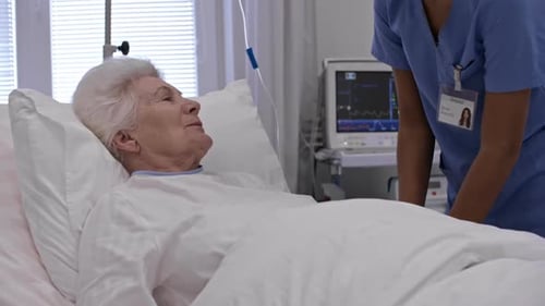 Senior Female Patient Talking with Nurse during Procedure