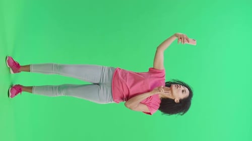 Woman Takes Selfie on Green Screen Background