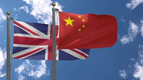 United Kingdom and China Flags Waving in Blue Sky