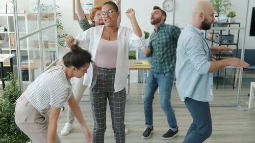 Slow Motion of Cheerful Employees Diverse Group Dancing Having Fun in Office