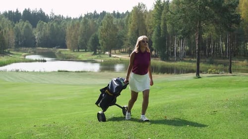 Summer Day Woman Playing Golf Walking with a Cart in Her Hands Golf Clubs in Her Bag View of Golf