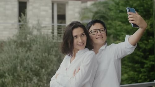 Smiling Women Take Selfie on Balcony Together