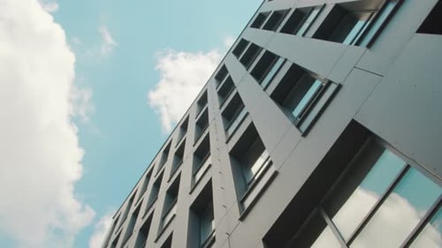 Part of the Facade of a Modern Business Center Building Is a Bottom-up View. The Sky Reflected in