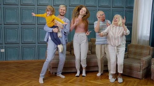 Cheerful Family Dancing Together in the Living Room