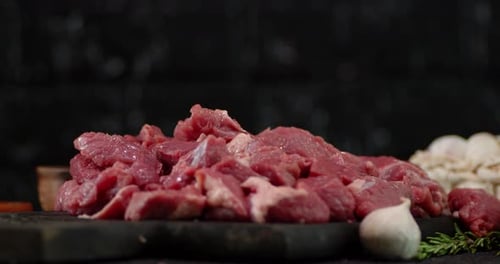 Pieces of Raw Beef Fall on the Table.