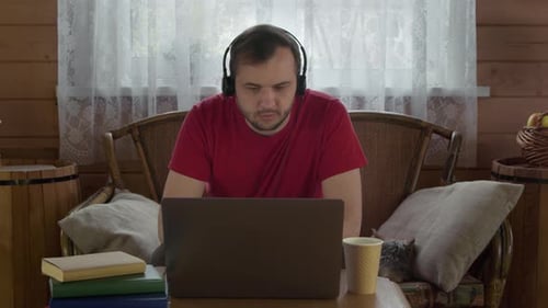 Young Handsome Man Works Remotely Talk By Webcam on Laptop at Home