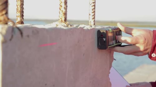 Building Engineer does Measurements of the Building