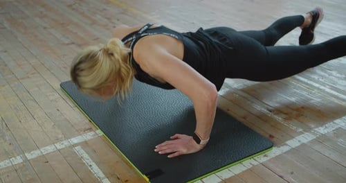 Woman Doing Push-ups on Gym Mat