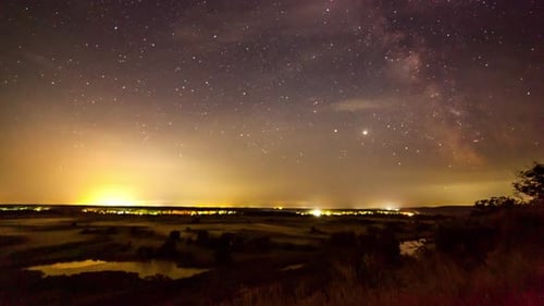 Starry Night Sky Over Rural Landscape