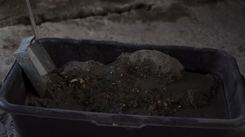 Mixing Gravel with Water in Tub Close Up