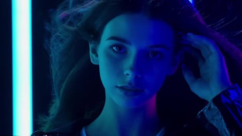 Woman Posing in Studio with Changing Neon Lights