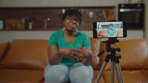 Woman Records Video with Smartphone at Home