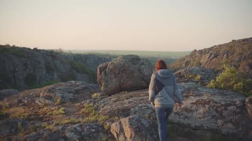 Eine junge Reisende geht in den Bergen am Canyon spazieren