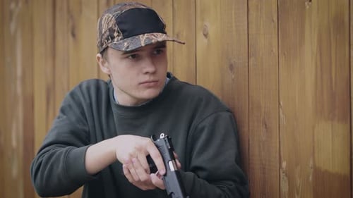 Joven hombre menor con una pistola