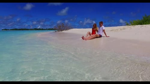 Family of two posing on tropical sea view beach break by turquoise lagoon with white sandy backgroun