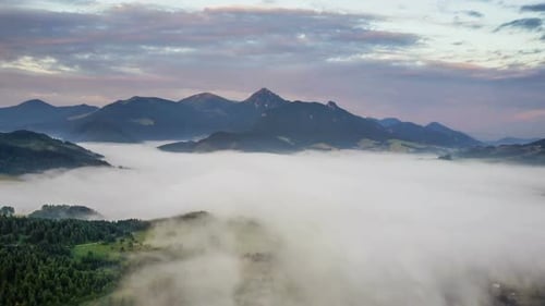 Aerial View of Mountains Covered in Thick Fog