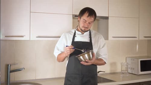 Chef Mixing Ingredients in Bowl in Bright Kitchen