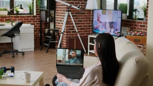 Office Employee Working Remotely While Attending Online Video Call with Executive Manager