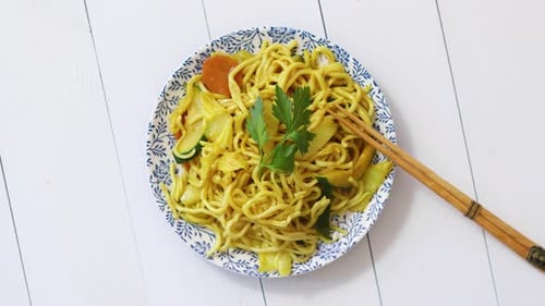 Overhead View of Vegetable Chow Mein with Chopsticks