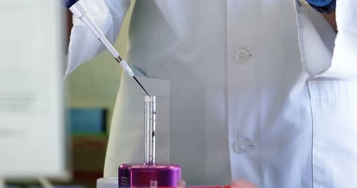 Scientist using pipette