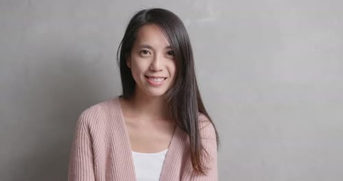 Smiling Young Woman in Pink Cardigan Close Up