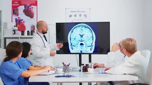 Medical Team Discusses Brain Scan at Conference Table