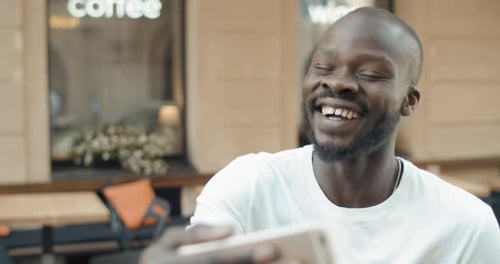 Young Adult Talking on Video Call Outdoors