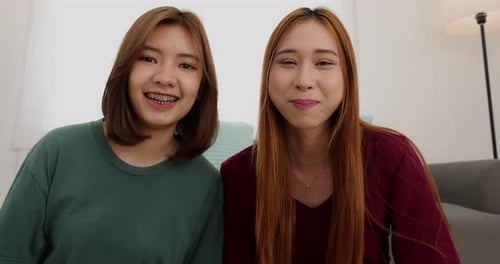 Happy Asian college student casual wear using computer working call video conference.