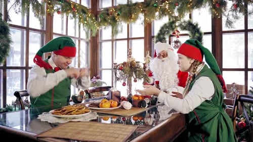 Santa and Elves Having Cookies at Christmas