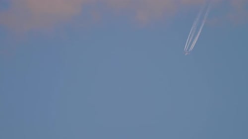 Passenger Airplane Flying Across a Blue Sky