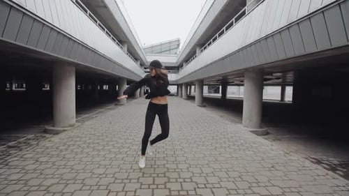 Stylish Woman Dancing in an Urban Parking Garage