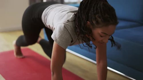 Young African American Female Athlete Working Out in the Living Room