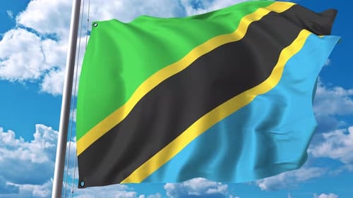 Realistic Waving Flag of Tanzania Against Blue Sky