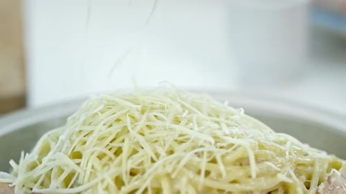 Grating Cheese on Hot Pasta