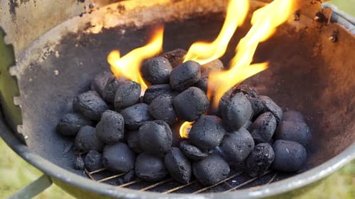 Closeup Of Glowing Coal In Metal Grill On Summer Day