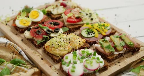 Delicious Open Sandwiches Displayed on Cutting Board