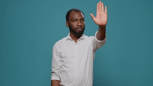 African American Model Raising Palm to Advertise Stop Sign