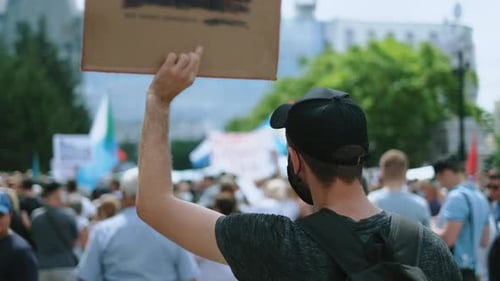 Protestors Gathering in City Holding Signs