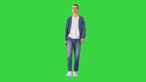 Young White Man Walks Slowly on a Green Screen Chroma Key