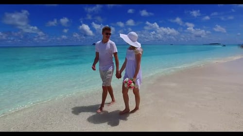 Romantic couple in love on tranquil sea view beach wildlife by turquoise sea and white sandy backgro