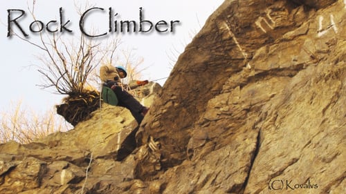 Person Rappelling Down Natural Rock Face